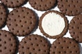 Texture background of rows of chocolate-cream cookies.