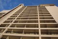 Upward view of a sand color high rise building wall with balconies Royalty Free Stock Photo