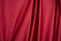 Texture, background, template. Silk fabric. Red silk drapery and upholstery fabric. Solid fabrics for backdrop, drapes, flags