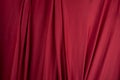 Texture, background, template. Silk fabric. Red silk drapery and upholstery fabric. Solid fabrics for backdrop, drapes, flags