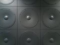 Texture background of wall with square panels with round speakers