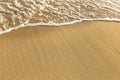 Texture of beach sea sand with a soft wave of surf. Summer. Royalty Free Stock Photo