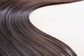 texture of beautiful glossy long hair.Curl female healthy hair. Concept hairdresser spa salon. strand of brunette silky