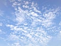 Texture of a beautiful light blue sky with white small clouds. The background Royalty Free Stock Photo