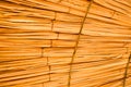 Texture of beautiful straw natural sun umbrellas from hay in a tropical desert resort, rest. The background Royalty Free Stock Photo