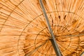 Texture of beautiful straw natural sun umbrellas from hay in a tropical desert resort, rest Royalty Free Stock Photo