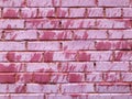 Texture of a beautiful unique unusual pink tender old cracked brick wall of rectangular bricks with seams painted with pink old Royalty Free Stock Photo