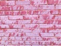 Texture of a beautiful unique unusual pink tender old cracked brick wall of rectangular bricks with seams painted with pink old Royalty Free Stock Photo