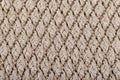 Texture of beige knitted woollen fabric