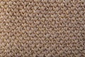 Texture of beige knitted woollen fabric