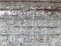 Texture of a black gray old dilapidated wooden wall, a fence with pieces of old shabby exfoliated paint from horizontal worn-out r Royalty Free Stock Photo