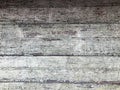 Texture of a black gray old dilapidated wooden wall, a fence with pieces of old shabby exfoliated paint from horizontal worn-out r Royalty Free Stock Photo