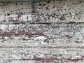 Texture of a black gray old dilapidated wooden wall, a fence with pieces of old shabby exfoliated paint from horizontal worn-out r Royalty Free Stock Photo