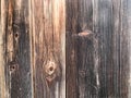 Texture of a black gray old wooden wall, charred from a fence of vertical old rambling boards of different sizes with cracks and k Royalty Free Stock Photo