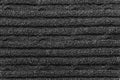 Texture of a black knitted sweater closeup. dark knitted wool material background