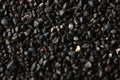 Texture of black volcanic sand for background. Black Sand beach macro photography. Close-up view of volcanic sand Royalty Free Stock Photo