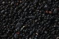 Texture of black volcanic sand for background. Black Sand beach macro photography. Close-up view of volcanic sand Royalty Free Stock Photo