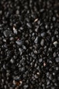 Texture of black volcanic sand for background. Black Sand beach macro photography. Close-up view of volcanic sand Royalty Free Stock Photo