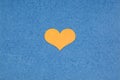 Texture of blue cardboard and yellow heart