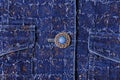 Texture of blue denim with gold threads. Beautiful blue button, pockets Royalty Free Stock Photo