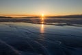 texture of blue ice cracks of Lake Baikal at sunset. Olkhon island