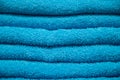 Texture of blue terry towel. A stack of soft bath accessories