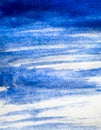 Texture of blue watercolour paint on white paper. Vertical background with stains of watercolor brush strokes.