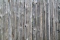 The texture of the boards of an old wooden fence closeup. Old wooden planks background Royalty Free Stock Photo