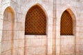 texture of the brick wall and the wooden brown old man of the ancient carved Arab Islamic Islamic triangular window with ornament Royalty Free Stock Photo