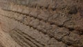 The texture of a broken tread of a truck on a rural road