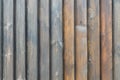 A texture of brown vertical boards with knots and resin painted with impregnation for wood