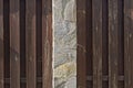 Texture of brown wooden boards and gray stone pillar Royalty Free Stock Photo
