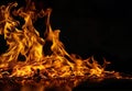 Texture of burning fire on a dark background. Burning flame Royalty Free Stock Photo