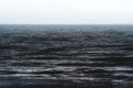 Texture of the cark blue silver shining ocean during storm in Spain Royalty Free Stock Photo