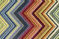 The texture of the carpet with bright multi-colored zigzags