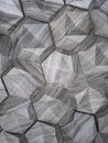 The texture of the ceramic tiles in the form of a hexagon made of natural stone of gray color with convex surfaces of a triangular Royalty Free Stock Photo