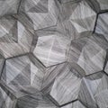 The texture of the ceramic tiles in the form of a hexagon made of natural stone of gray color with convex surfaces of a triangular