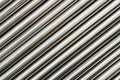 Texture of chrome steel pipe sort in diagonal, abstract background