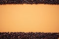 Texture, coffee bean frame on orange background, space for text