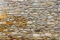 Texture collapsing stone wall of old house with brick masonry