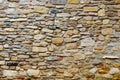 Texture collapsing stone wall of old house with brick masonry