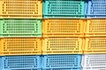 Texture from colored plastic colored yellow blue green rectangular boxes with holes for goods, bottles Royalty Free Stock Photo