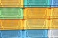 Texture from colored plastic colored yellow blue green rectangular boxes with holes for goods, bottles Royalty Free Stock Photo