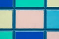 Texture of a colorful mosaic of concrete slabs. Abstract pattern of multicolored squares on a concrete wall. Colorful painted bloc