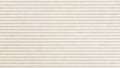 Texture of corrugated striped craft paper, light cream color. Abstract background