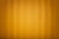 Texture of corrugated yellow paper with vignette, macro