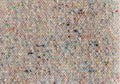 The texture of the costume fabric boucle with colored inclusions