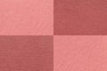 Texture of craft dark pink and maroon paper background with cells pattern, macro. Vintage dense kraft rose cardboard