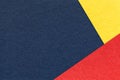 Texture of craft navy blue color paper background with yellow and red border. Vintage abstract denim cardboard. Royalty Free Stock Photo