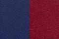 Texture of craft navy blue and dasrk red paper background, half two colors, macro. Structure of wine craft cardboard